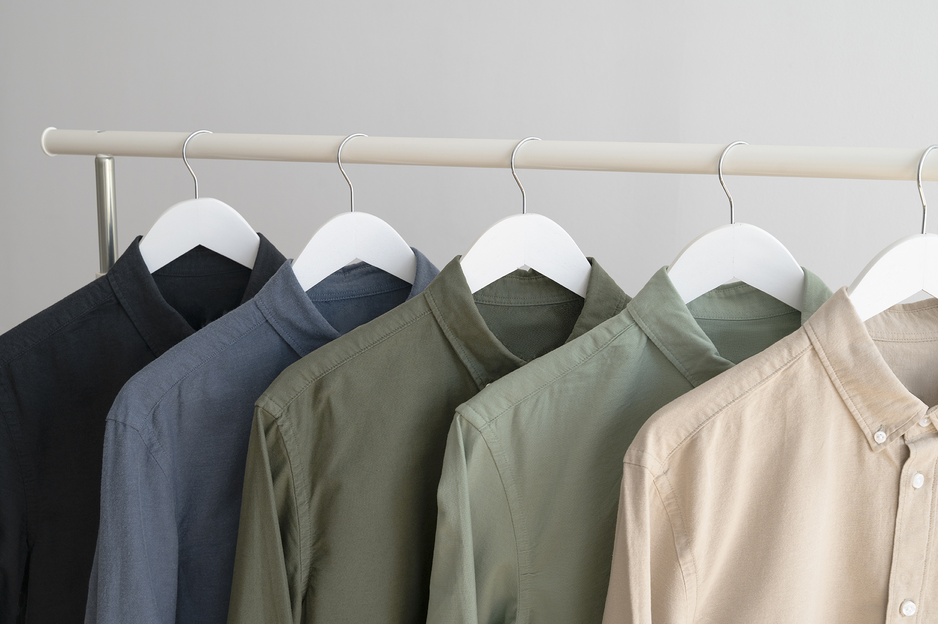 Blue and green sustainable shirts hanging